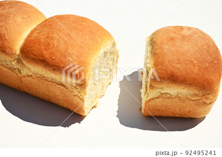Close-up. Cropped view of loaves of freshly baked whole grain bread isolated on white background with copy ad space Close-up. Cropped view of loaves of freshly baked whole grain bread isolated on white background with copy ad space 92495241