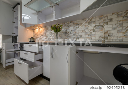 Renovated Interior for modern trendy white kitchen with doors open Renovated Interior for modern trendy white kitchen with doors open 92495258