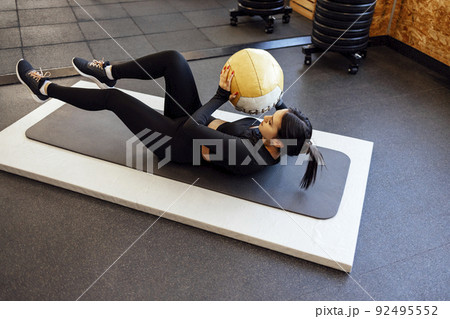Fitness woman training with medicine ball 92495552