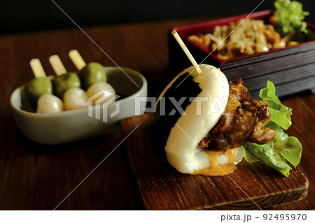 Hirata buns. Japanese steamed buns filled with pork chashu, tempura, karaage. Japanese traditional food Hirata buns. Japanese steamed buns filled with pork chashu, tempura, karaage. Japanese traditional food 92495970