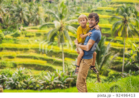 Dad and son travelers on Beautiful Rice Terraces against the background of famous volcanoes in Bali, Indonesia Traveling with children concept 92496413