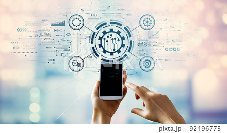 Automation concept with hand pressing a smartphone Automation concept with hand pressing a smartphone 92496773