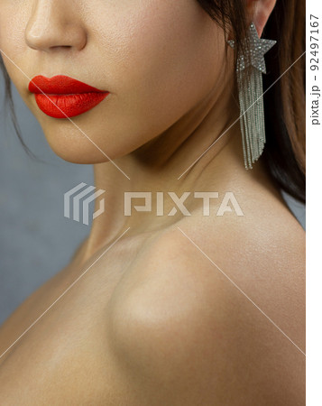 Close-up happy female smile with healthy white teeth, bright red gloss lips make-up. Cosmetology, dentistry and beauty care. Macro of woman's smiling mouth 92497167