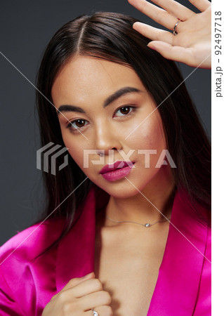 beautiful woman in a pink mini dress luxury Gray background 92497718