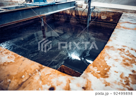 Tank with waste water in steel plant workshop Tank with waste water in steel plant workshop 92499898