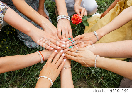 Multiracial group of friends with hands in stack. Teamwork Multiracial group of friends with hands in stack. Teamwork 92504590