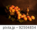 Image Decoration from fresh apricots. Still life, nature morte in dramatically dark setting and background. 92504834