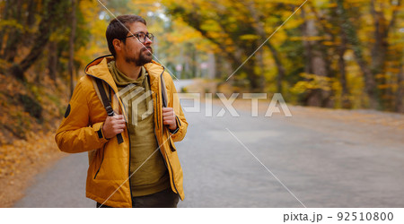 Young handsome man posing in autumn forest. 92510800
