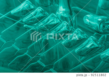 Glass medical ampoule vial for injection. Medicine is liquid sodium chloride with of aqueous solution in ampulla. Close up. Bottles ampule multicolor. Glass medical ampoule vial for injection. Medicine is liquid sodium chloride with of aqueous solution in ampulla. Close up. Bottles ampule multicolor. 92511802