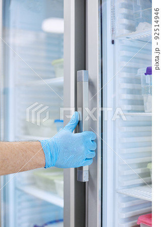 The scientist takes samples of materials for experiments out of the refrigerator The scientist takes samples of materials for experiments out of the refrigerator 92514946
