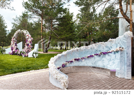 Outdoor wedding ceremony with umbrellas in the forest 92515172