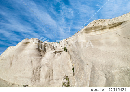 Famous white rocks of Sarakiniko beach, Aegean sea, Milos island , Greece. No people, empty cliffs, summer sunshine, lunar landscape, blue sky, clouds Famous white rocks of Sarakiniko beach, Aegean sea, Milos island , Greece. No people, empty cliffs, summer sunshine, lunar landscape, blue sky, clouds 92516421