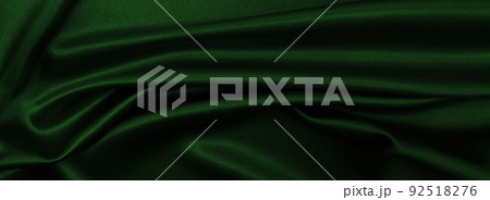 Smooth elegant green silk or satin luxury cloth texture as abstract background. Luxurious background design 92518276