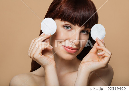 Close-up portrait of nude positive red-haired girl with shiny pure clean fresh smooth flawless skin Close-up portrait of nude positive red-haired girl with shiny pure clean fresh smooth flawless skin 92519490