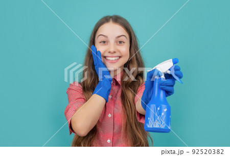 amazed kid in rubber gloves with spray bottle on blue background 92520382