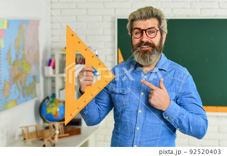 geometric shapes. physics research. math teacher at blackboard. education. exact sciences. happy bearded teacher in glasses. back to school. develop logic and creativity. start the brain engine geometric shapes. physics research. math teacher at blackboard. education. exact sciences. happy bearded teacher in glasses. back to school. develop logic and creativity. start the brain engine 92520403