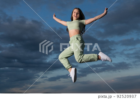 happy teen girl jump high on sky background happy teen girl jump high on sky background 92520937