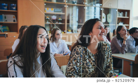 Pupils of the 11th grade in the class at the desks during the lesson. Russian school. 92520979
