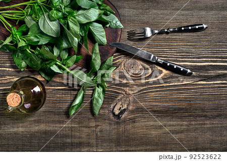 Green fresh basil on wooden background. Top view Green fresh basil on wooden background. Top view 92523622
