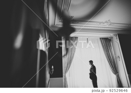Beautiful man, groom posing and preparing for wedding Beautiful man, groom posing and preparing for wedding 92529646