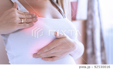 Breast pain self exam. Young pregnancy woman examining breast for signs lumps. Breast self exam. Health, medicine and beauty concept. 92530016