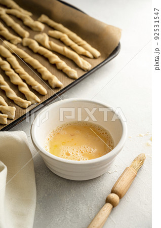 Cooking baking grissini sticks, grissini,raw dough and egg mixture 92531547