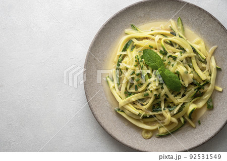 Zucchini courget spaghetti pasta with cheese, clean eating, vegan food, low carb healthy food 92531549