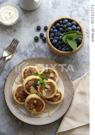 Cottage cheese fritters, ricotta pancakes with sour creamand bleberries. Healthy food. Top view. 92531773