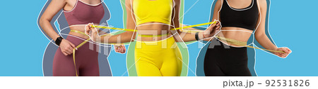 Cropped young ladies athlete in sportswear with overweight women drawn around measures waist with measuring tape Cropped young ladies athlete in sportswear with overweight women drawn around measures waist with measuring tape 92531826
