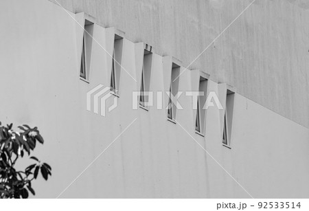 6 small windows bring light into a large building. 92533514