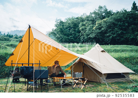 森の中でテントを張ってキャンプする日本人男性（アウトドア） 92535583