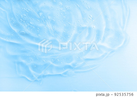 Hyaluronic acid fluid skincare product with bubbles. Blue jelly sanitiser abstract pattern, cleansing emulsion macro. 92535756