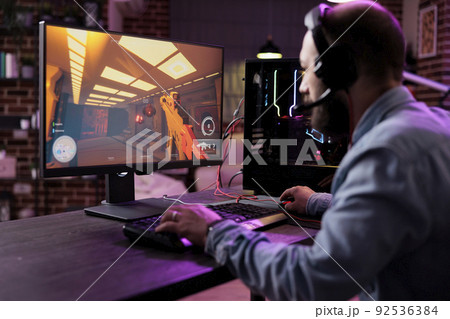 Caucasian player enjoying live stream with video games, playing action rpg competition on online web tournament. Male gamer streaming esport gameplay championship in living room. Caucasian player enjoying live stream with video games, playing action rpg competition on online web tournament. Male gamer streaming esport gameplay championship in living room. 92536384