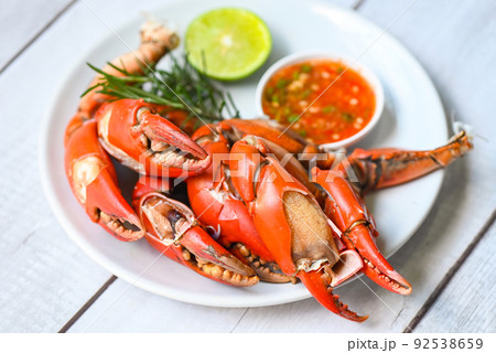 claw crab cooking food seafood plate with chili herbs spices lemon lime salad, fresh crab on white plate seafood sauce, boiled or steamed crab red in the restaurant claw crab cooking food seafood plate with chili herbs spices lemon lime salad, fresh crab on white plate seafood sauce, boiled or steamed crab red in the restaurant 92538659