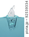object falling into blue water until splashing on a gray background, 92539334