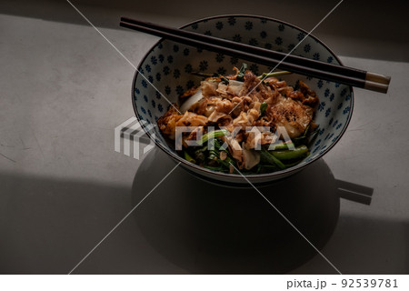 Stir fried flat noodle and Chicken with dark soy sauce and vegetables (Thai people called Pad See Ew), It is one of the most popular street food in the world. Stir fried flat noodle and Chicken with dark soy sauce and vegetables (Thai people called Pad See Ew), It is one of the most popular street food in the world. 92539781