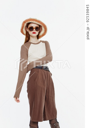 Stylish professional lady in a hat female model posing in the studio on a white background in motion. Banner for a new collection, discounts and sales 92539845