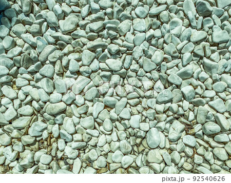 texture, small, gray stones lie on the road. material for the construction of roadsides and roads, stones for decorative figures 92540626