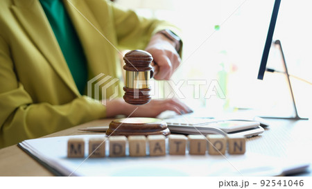 Female hand striking gavel in court room Female hand striking gavel in court room 92541046