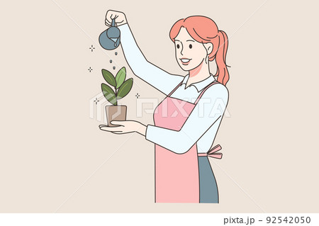 Happy woman watering plant 92542050