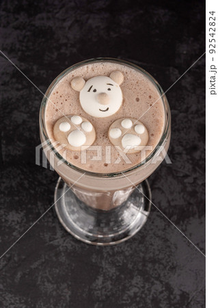 cocoa drink decorated with funny cookies on a dark background cocoa drink decorated with funny cookies on a dark background 92542824