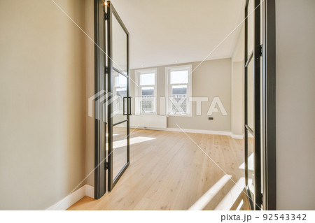 Plastic window and radiator on white wall in empty light room at home 92543342