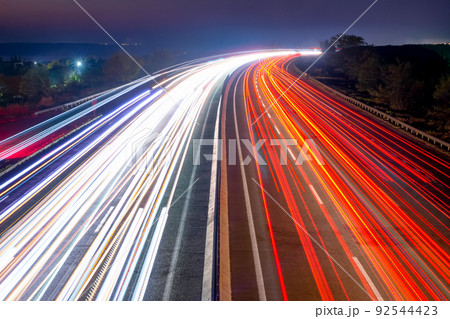 Night Car Traffic With Light Trails on a Suburban Highway Night Car Traffic With Light Trails on a Suburban Highway 92544423