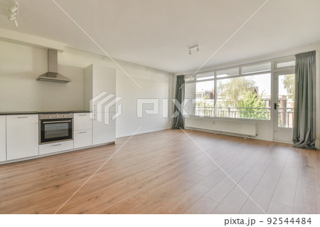 Interior of empty white kitchen with windows and wooden parquet floor Interior of empty white kitchen with windows and wooden parquet floor 92544484