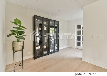 Counter with chairs dividing kitchen with modern furniture from dining area in contemporary flat 92545008