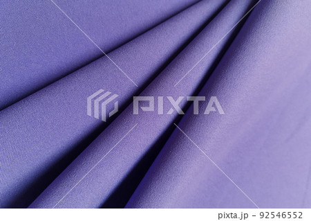 Violet crumpled or wavy fabric texture background. Abstract linen cloth soft waves. Gabardine wool fabric. Merino yarn. Smooth elegant luxury cloth texture. Concept for banner or advertisement. 92546552