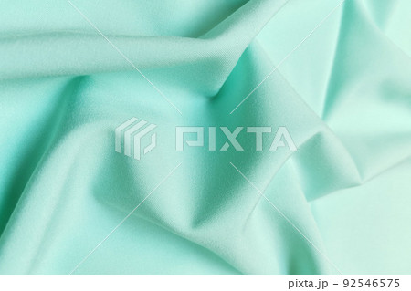 Green galliano fabric crumpled or wavy fabric texture background. Abstract linen cloth soft waves. Viscose yarn. Smooth elegant luxury cloth texture. Concept for banner or advertisement. Green galliano fabric crumpled or wavy fabric texture background. Abstract linen cloth soft waves. Viscose yarn. Smooth elegant luxury cloth texture. Concept for banner or advertisement. 92546575