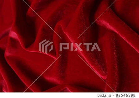 Red velvet crumpled or wavy fabric texture background. Abstract linen cloth soft waves. Merino yarn. Smooth elegant luxury cloth texture. Concept for banner or advertisement. 92546599