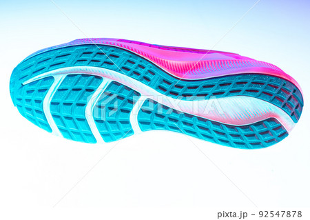 Aerial view of sole of sports shoes, sneakers isolated over white neoned background. Urban city fashion, fitness, sport, training concept. 92547878