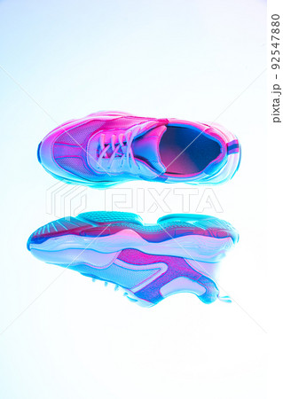Modern sports shoes over neoned background. Sneakers or trainers isolated. Athletic shoes. fitness, sport, training concept. Urban fashion 92547880